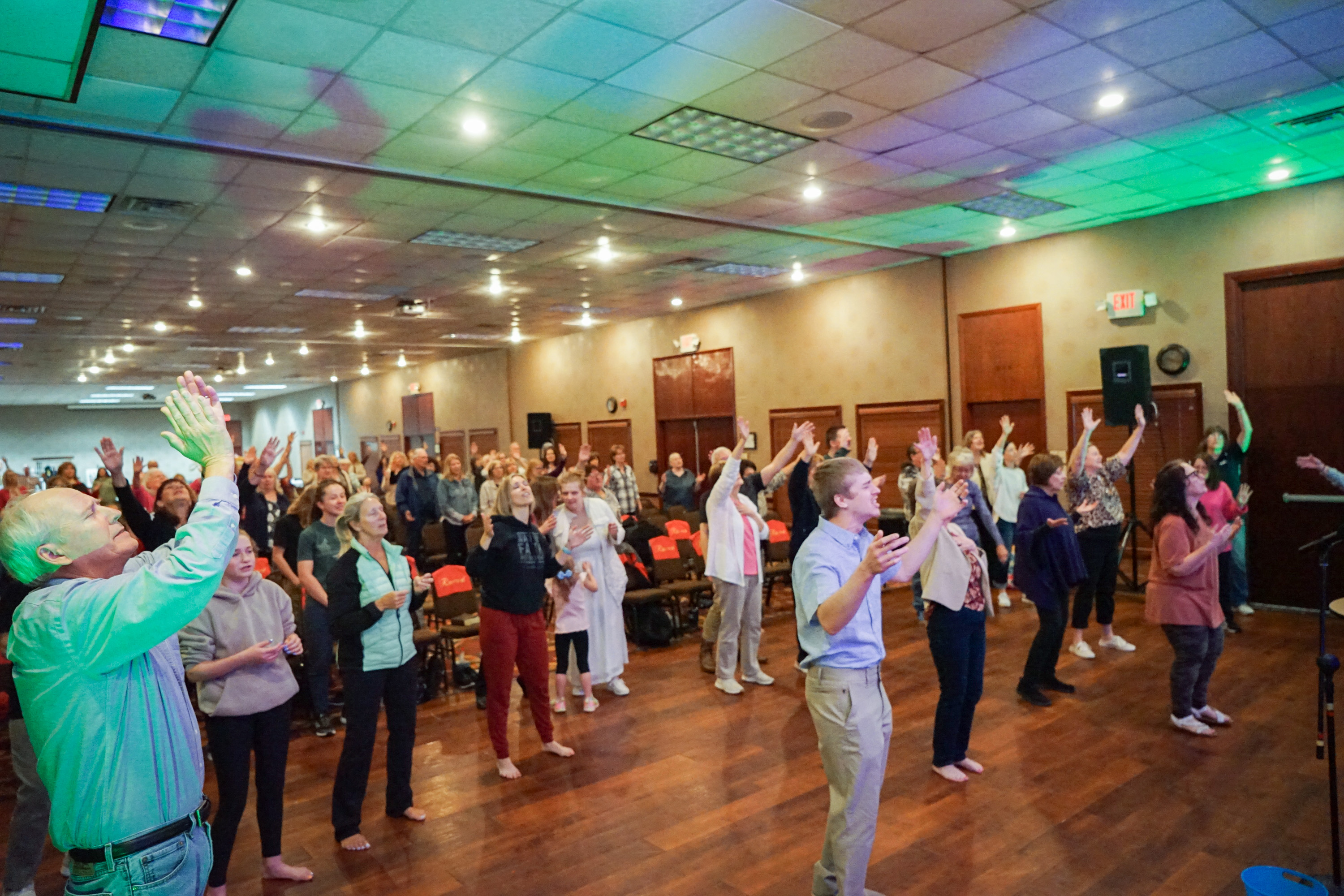 Congregation encountering God's presence together under green lights