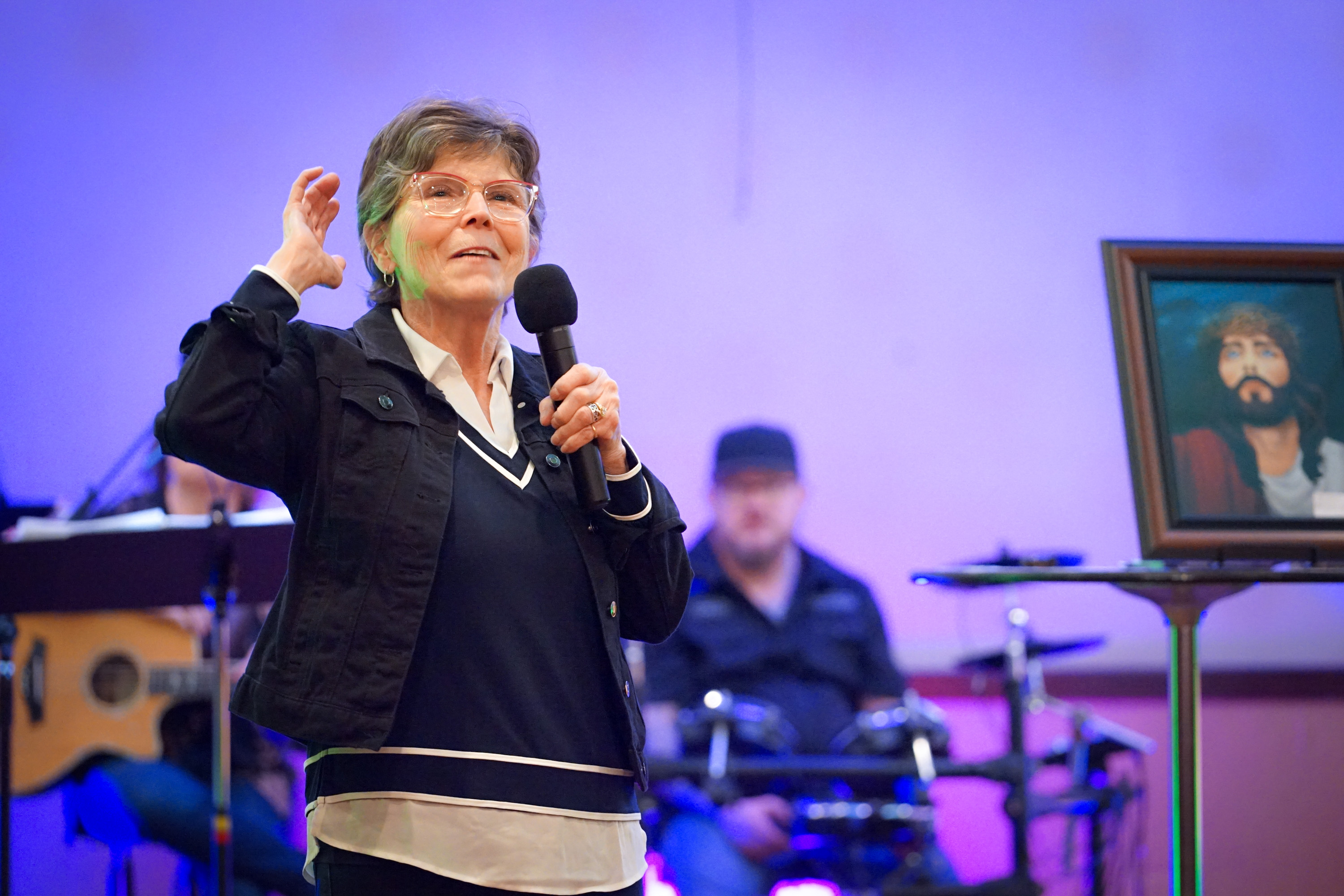Linda Lentner with hand raised in worship
